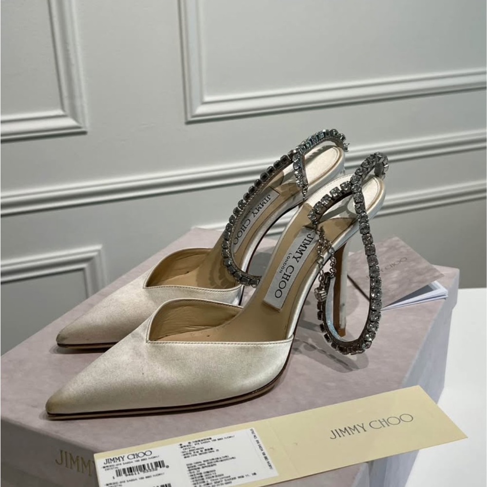 Jimmy Choo White Heels with Slingback Design and Metallic Stiletto